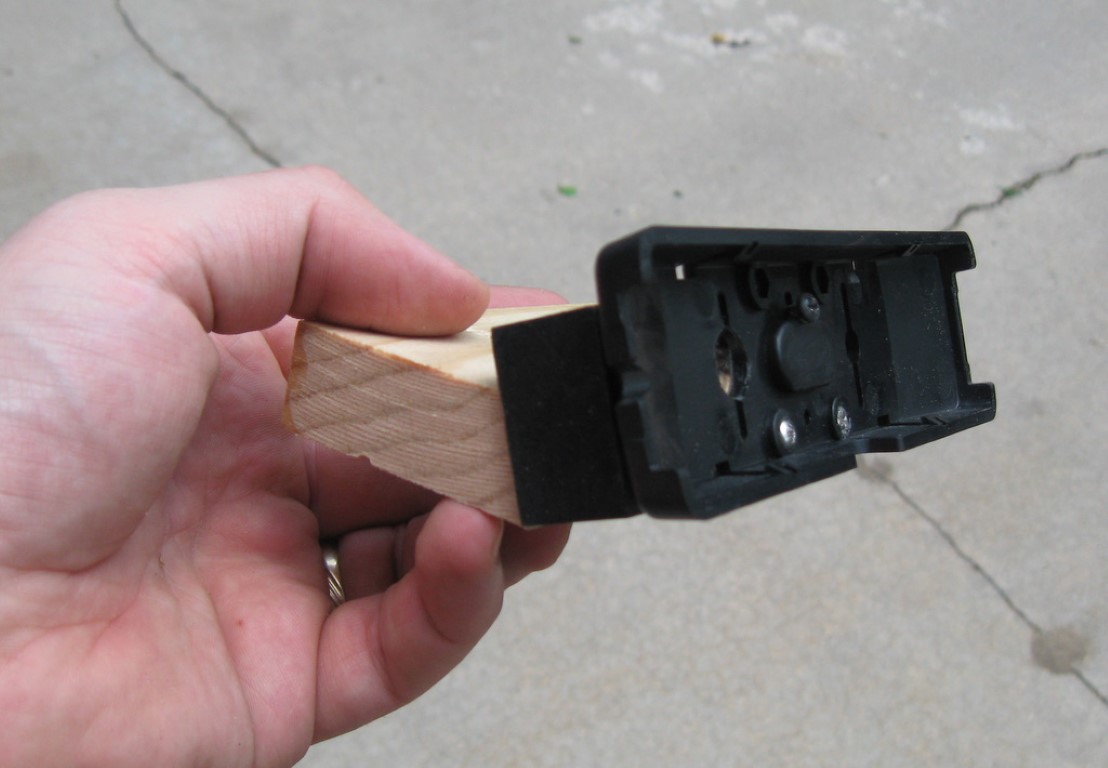 A wooden block attached to the back of the remote face mount to angle the face up towards the operator.