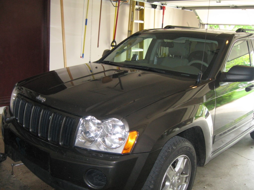 The lip-mount dual band antenna on the edge of the hood, in front of the driver.