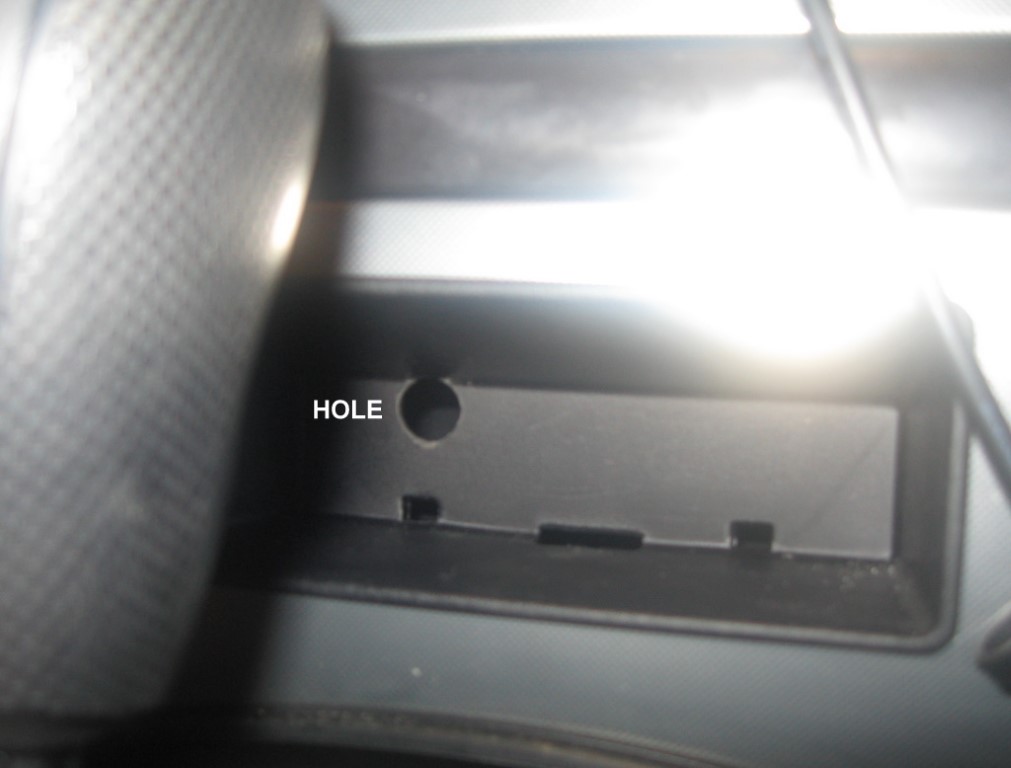 Hole drilled in the rear of the cubby hole in the dash.