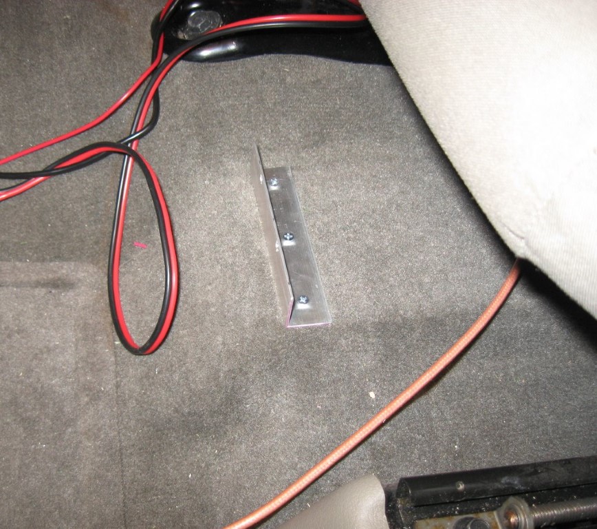 Angle aluminum mounted to the floor under the drivers seat to keep the radio body in place.