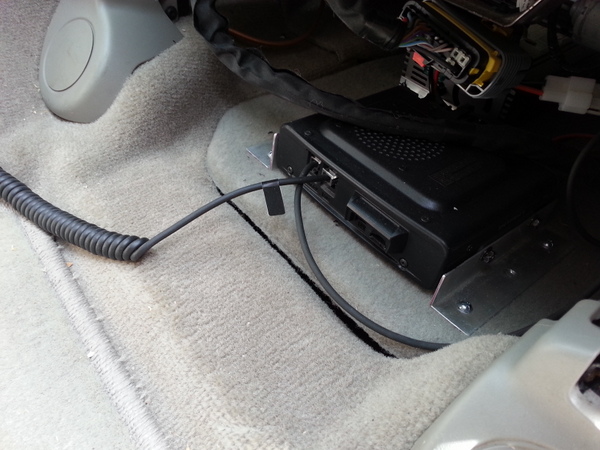 The removable plate under the drivers seat, with the radio mounted to it.