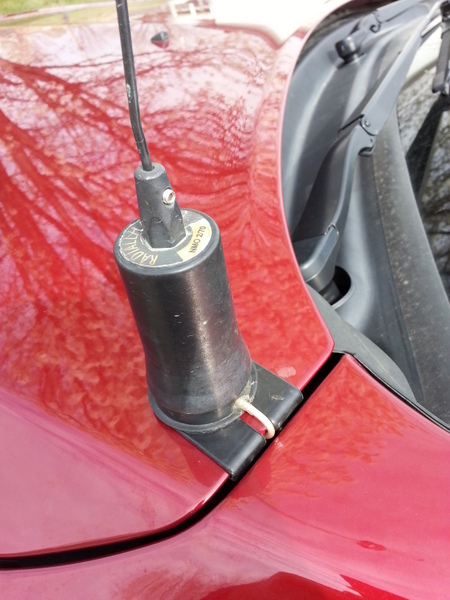 The dual band antenna lip-mounted to the edge of the hood in front of the driver.