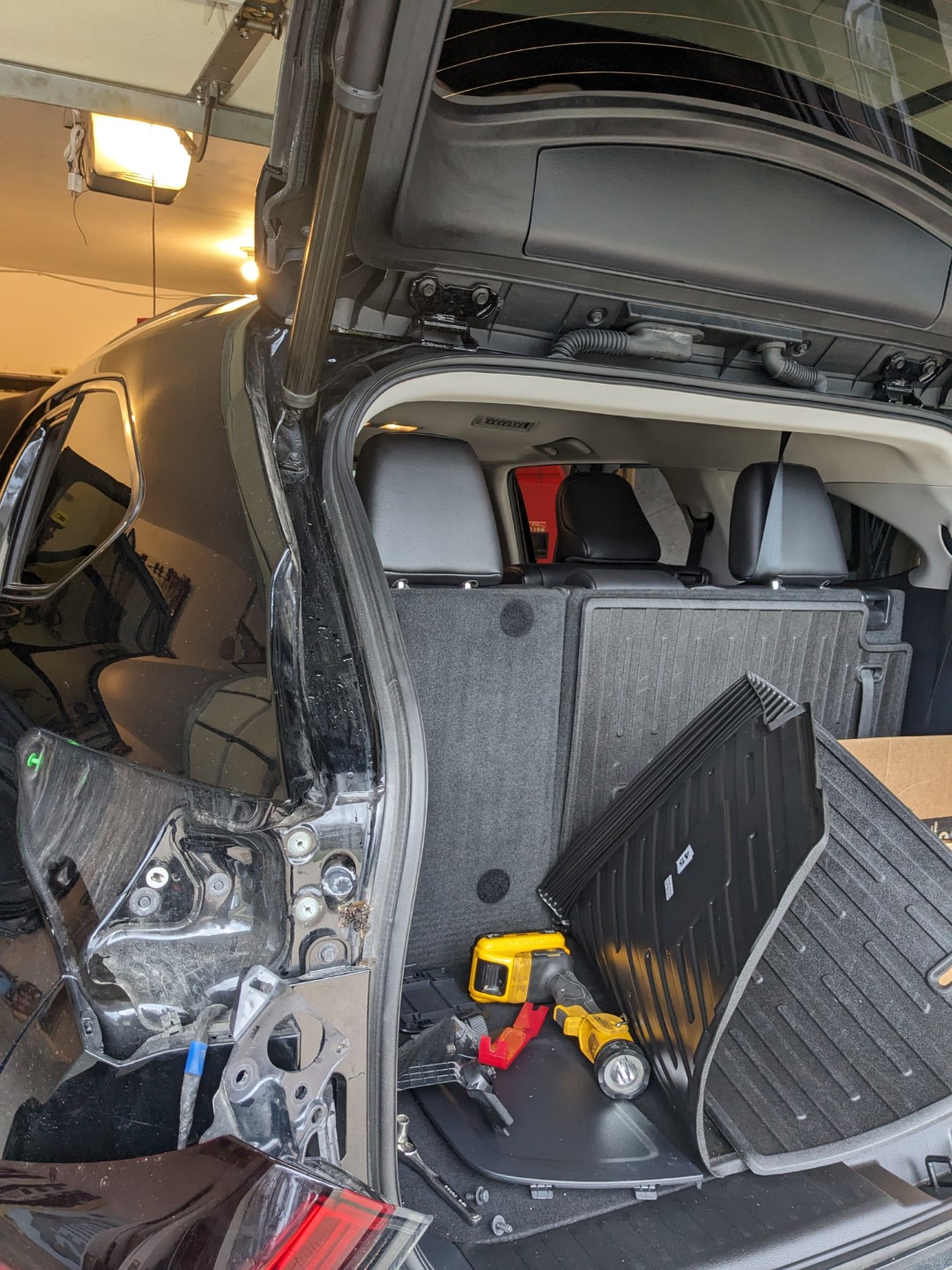 Removing the drivers side brake light to pass the coax cable through from the passenger compartment into the hatch hinge.