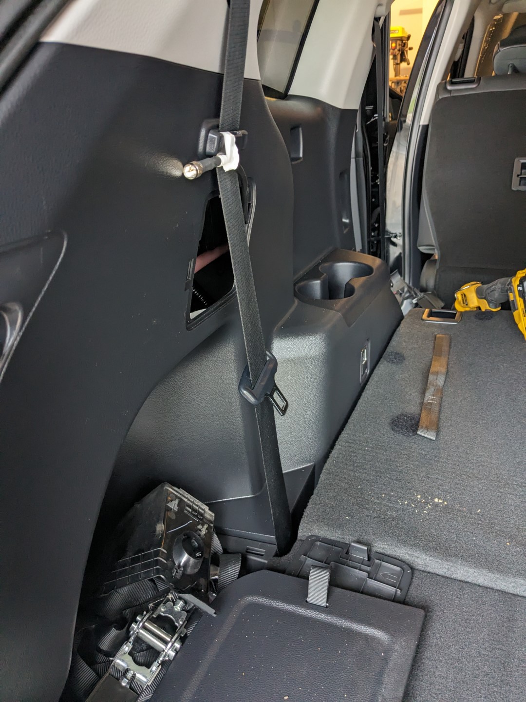 The coax being fed rearward into the access panel near the rear seats.