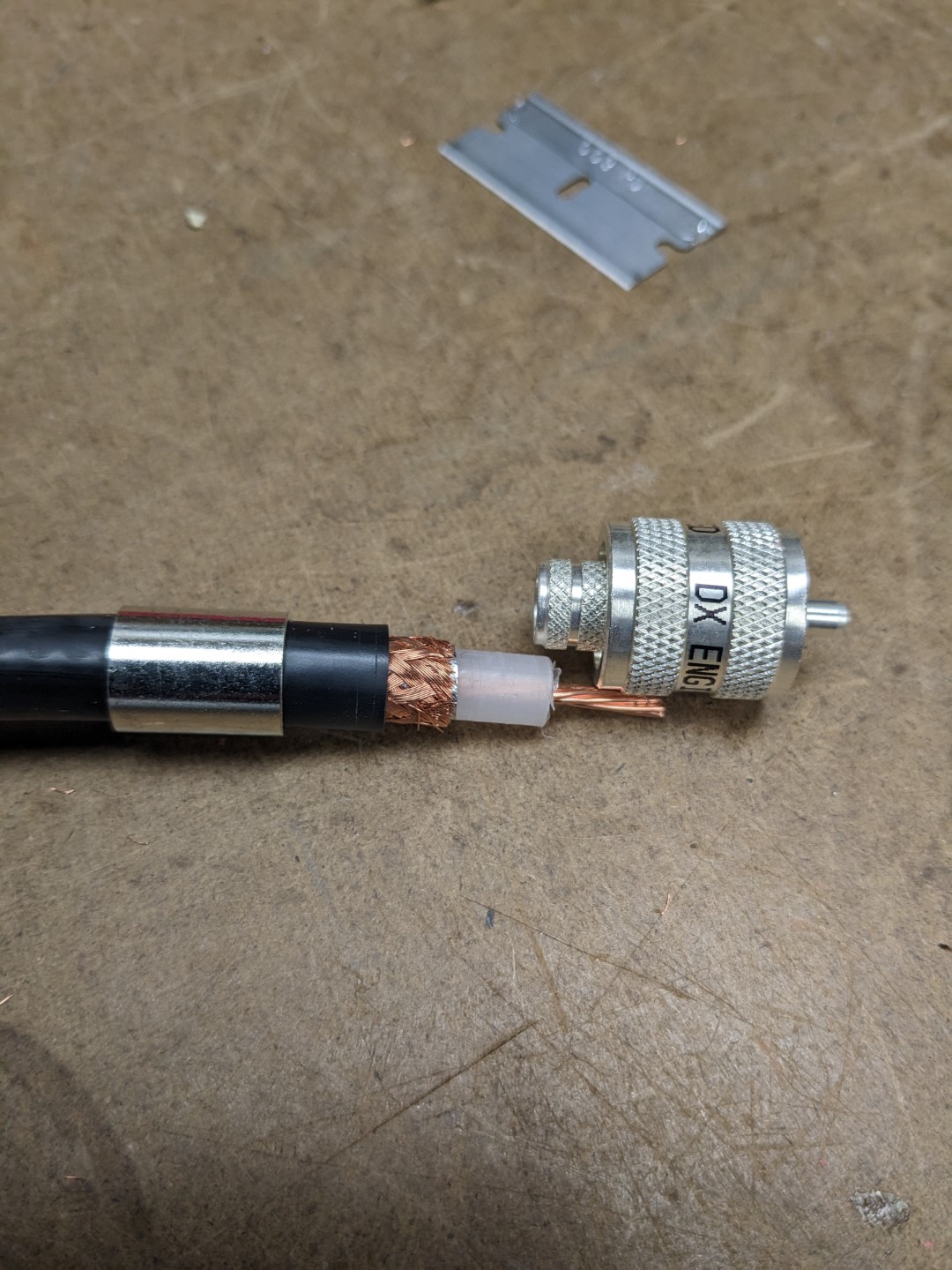 The prepped coax with the crimp-on connector sitting beside it.