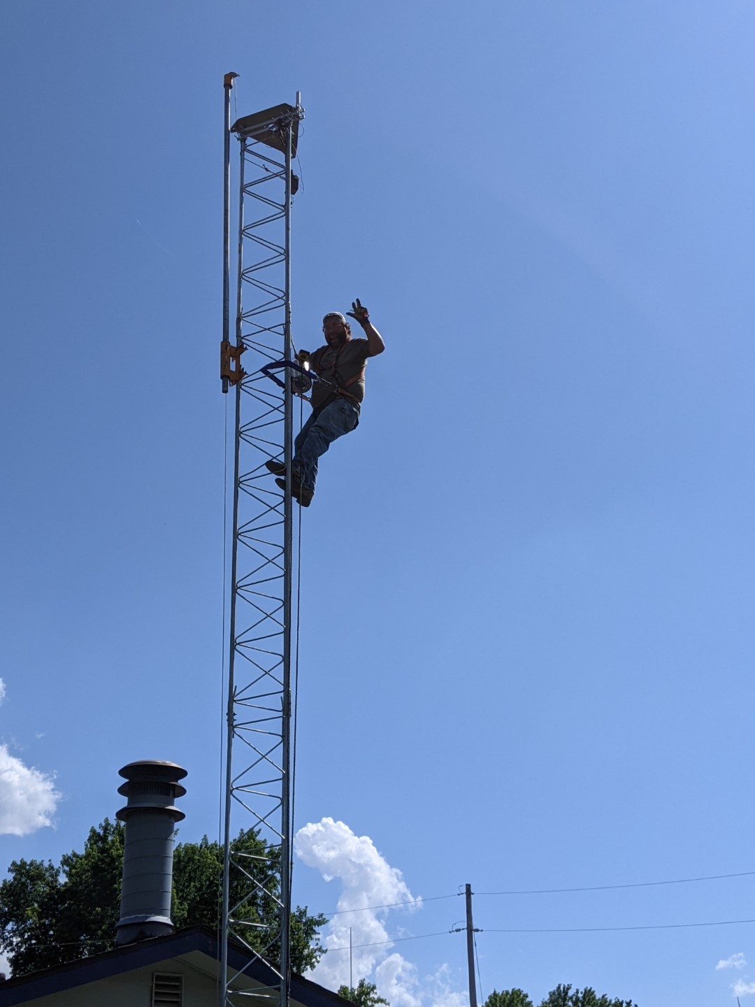 Jake, KB0ZIA posing for a picture before installing the antennas on the top of the new tower.